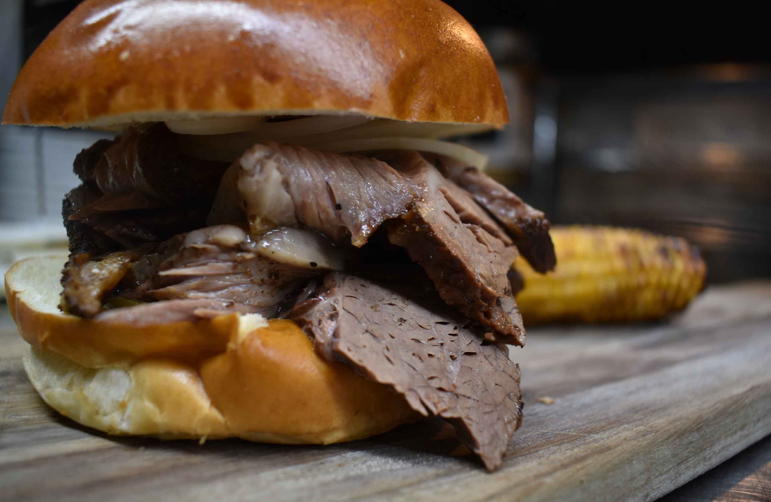 Smoky Rock BBQ brisket sandwich on a brioche roll