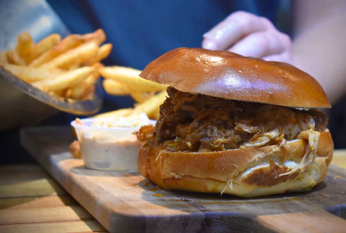 Smoky Rock BBQ pulled pork sandwich with a side