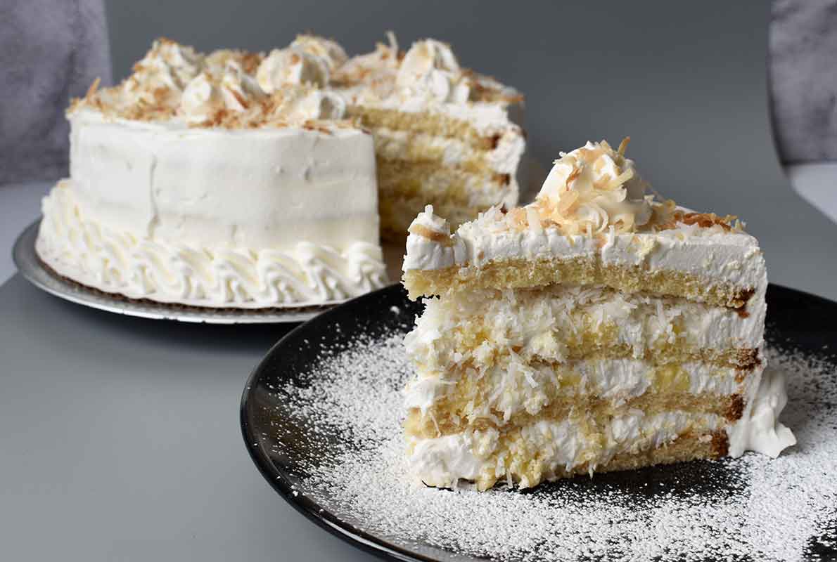 Coconut cake slice and whole cake from Smoky Rock Bakery