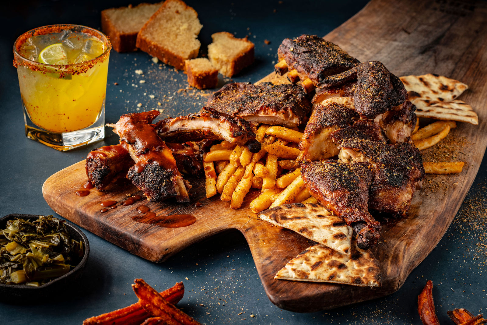 Smoky Rock BBQ smoked ribs, chicken, fries, flatbread, sides, and cocktail