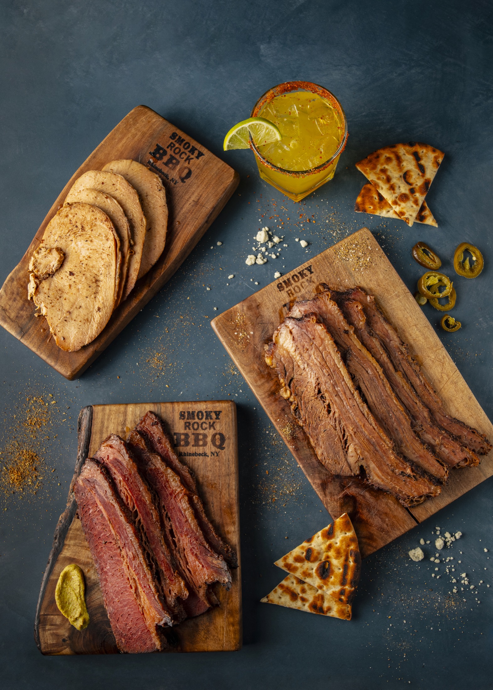 Smoky Rock BBQ sliced house-smoked meats with bread and pickles